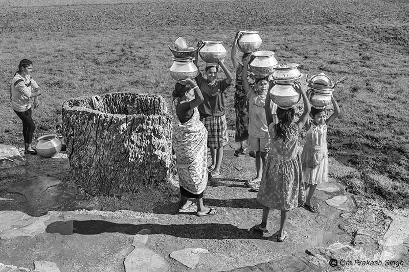 Ready to return home with drinking water from the Kukuru Daarhi in Jiuri village, Jharkhand, India